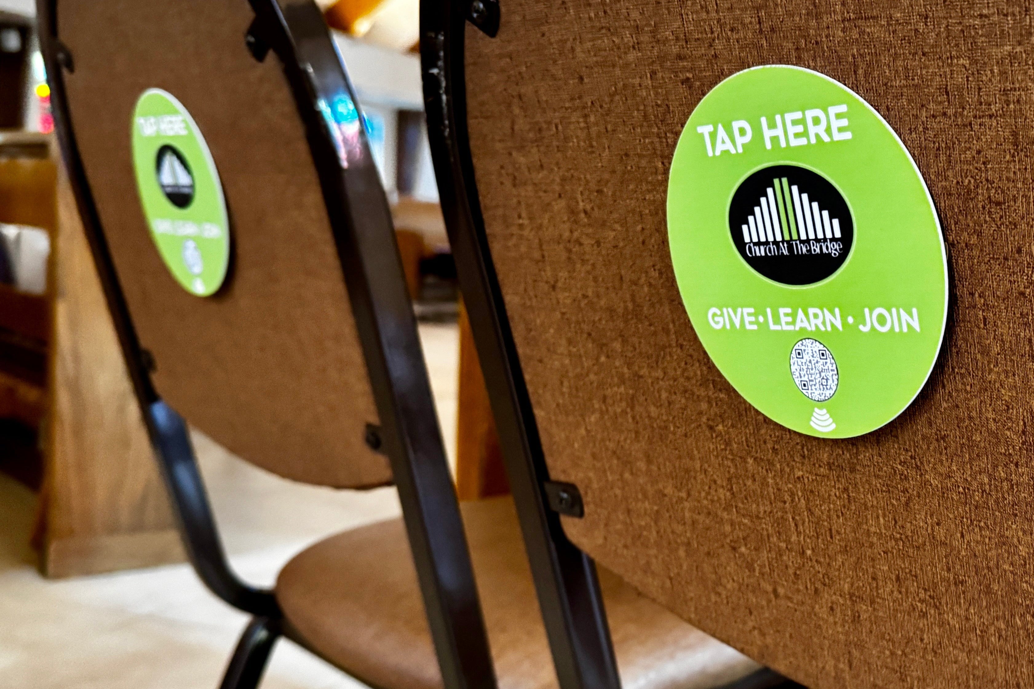 tap to scan qr sign on church chair