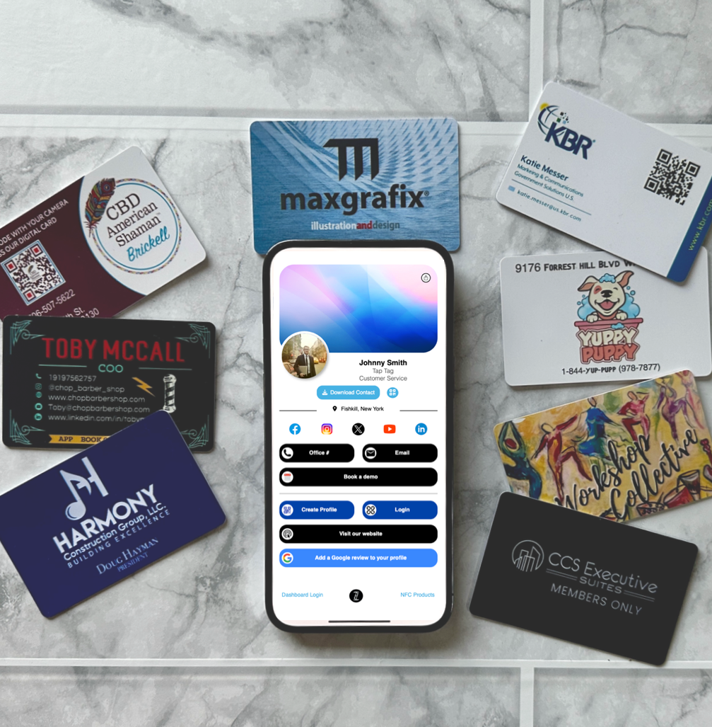 Collection of various business cards on a marble surface with a smartphone displaying a social media app.