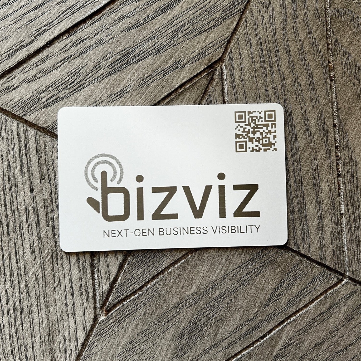 Custom White Tap Metal Business Card. Engraved silver on white. Tap to share contact information and digital profile